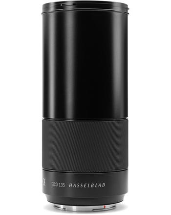 Hasselblad XCD 135mm f/2.8 medium format lens standing upright, side view showing focus ring and branding