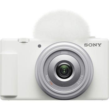 Front view of white Sony ZV 1F vlog camera with 20mm f/2.0 lens and top windscreen attached.