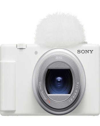 Front view of white Sony ZV-1 II digital compact camera with Zeiss zoom lens and top windscreen.