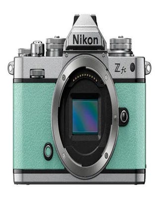 Front view of Nikon Z fc mirrorless camera body in green, showing DX sensor and retro silver top plate.