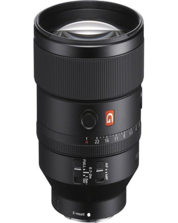 Angled product shot of Sony FE 135mm f/1.8 GM E-mount lens with aperture and focus switches