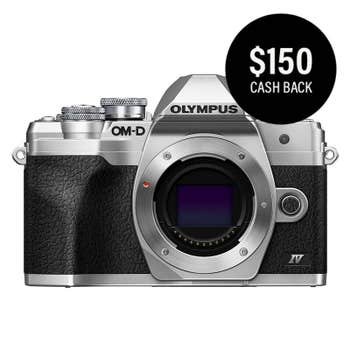 Olympus OM-D E-M10 Mark IV silver camera body front view with $150 cashback badge