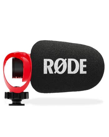 Rode VideoMicro II shotgun microphone with foam windshield and HELIX red isolation mount, side view