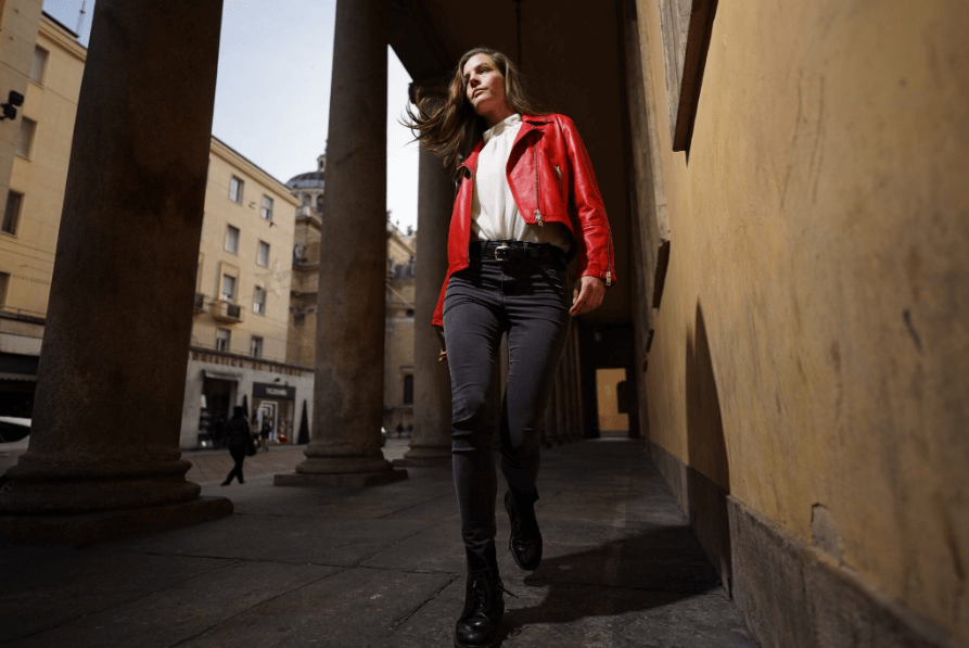 Portrait of stylishly dressed woman walking down colonnade, photographed with the Sony FE 20mm f1.8 G lens