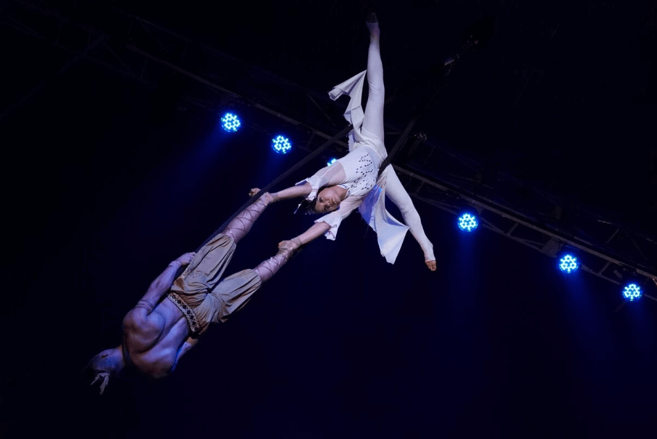 Male and female acrobats performing together on a trapeze, photographed with the Sony 70-200mm f4 G OSS Lens