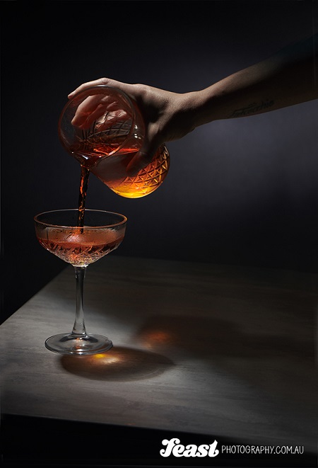 food photography pouring alcohol to a glass