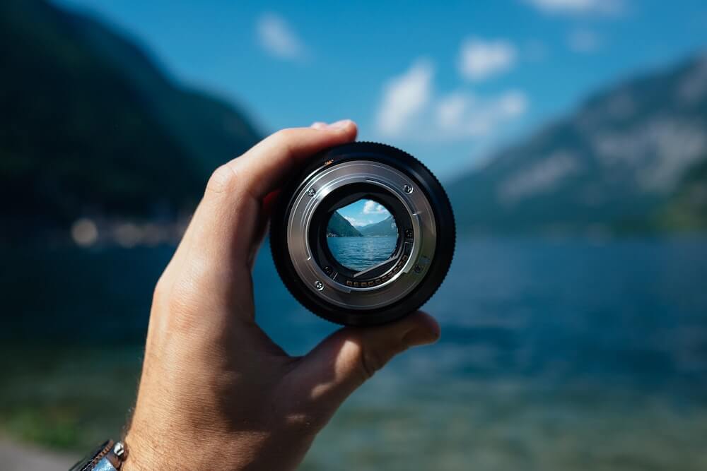 A vlogging lens pointed towards a beautiful lake