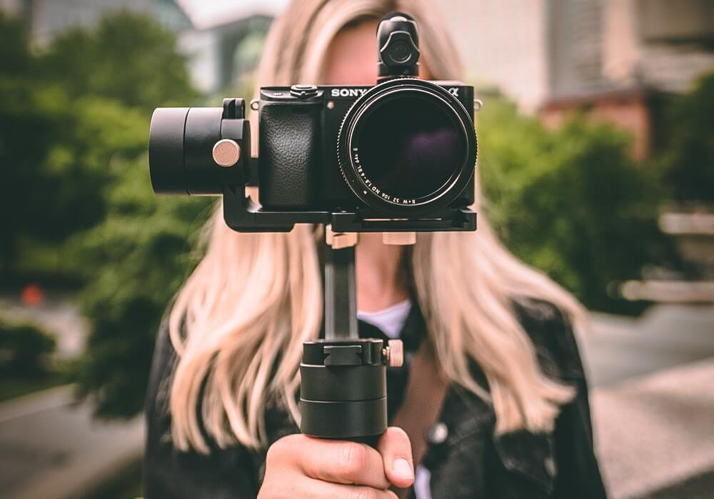 Vlogger holding a sony digital camera with Gimbal