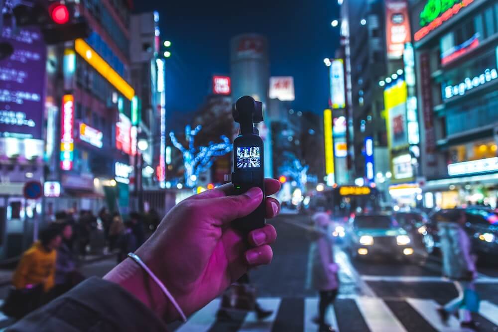 A guy in Japan holding a small vlogging camera