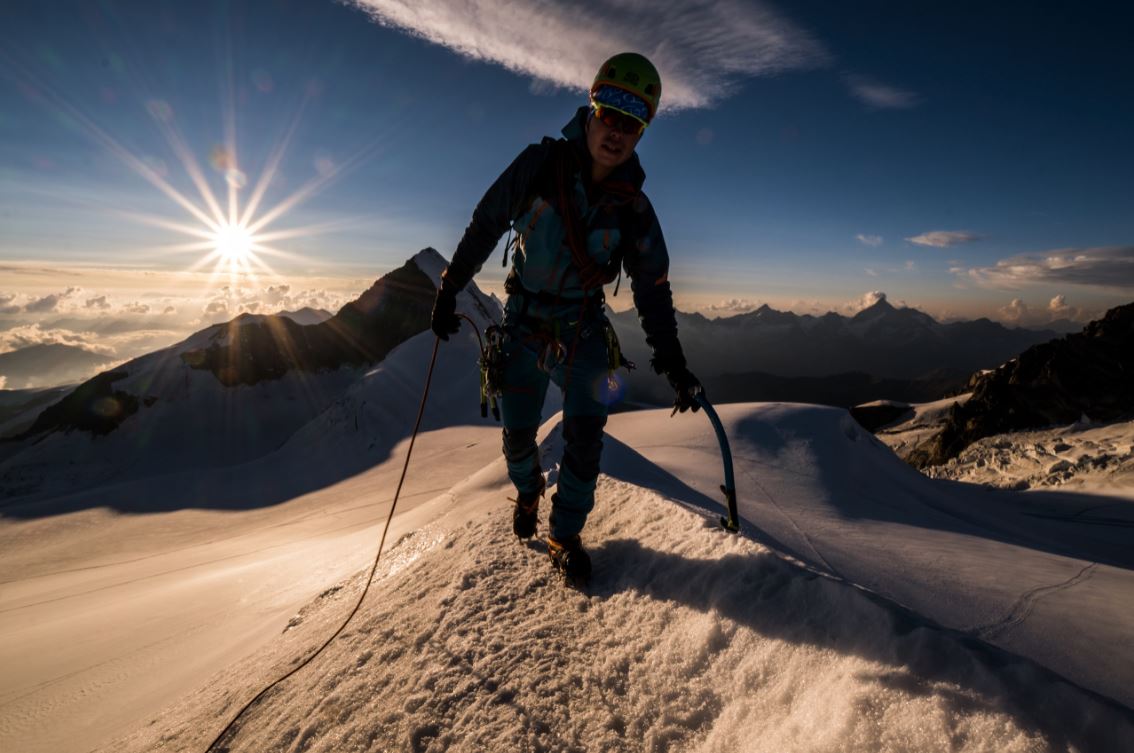Mountain climber walking across a snowy ridge, photographed with the Fujifilm XF 10-24mm f4 R OIS WR Lens